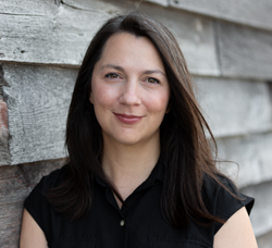 Smiling woman facing camera outside 